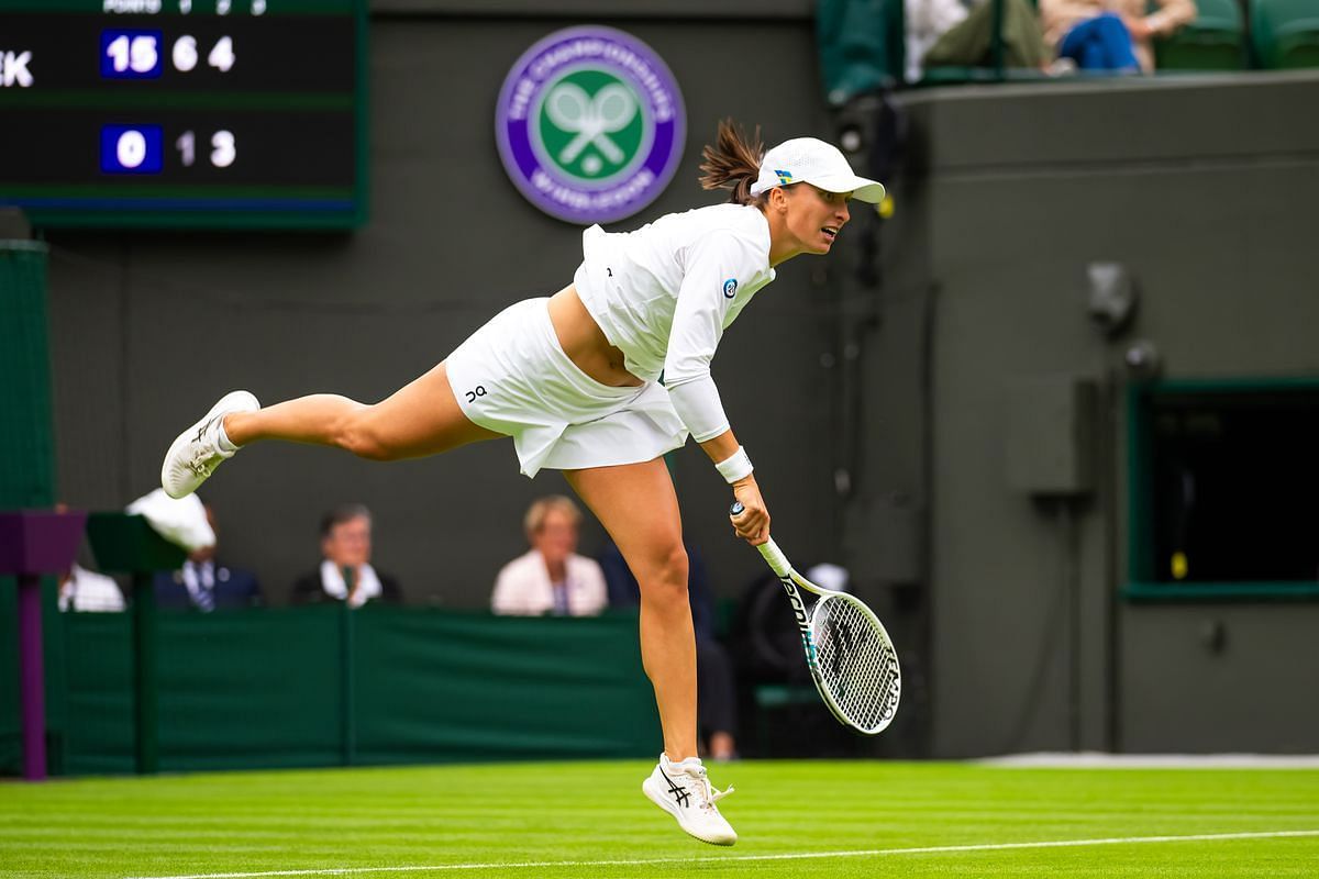Iga Swiatek hits a first serve at the 2023 Wimbledon Championships.